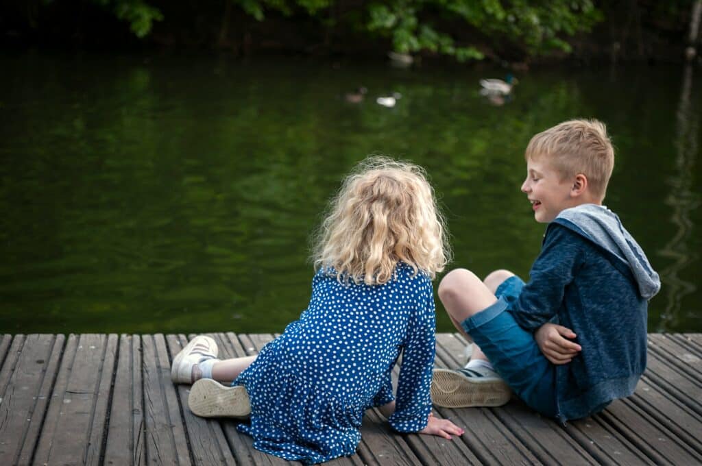 girl and boy in blue playing