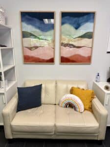 Minimalist therapy office with soft lighting and neutral tones, arranged to feel welcoming, calm, and professionally grounded