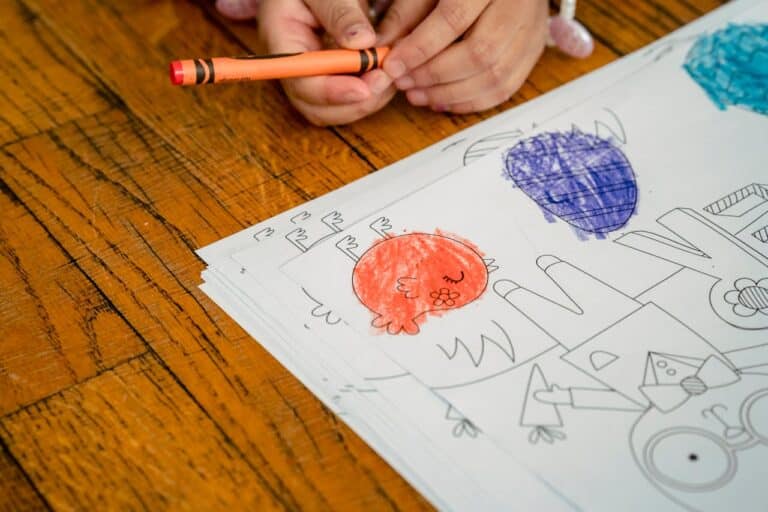 Child coloring with crayons during a pediatric neuropsychological evaluation to assess learning, attention, and fine motor skills