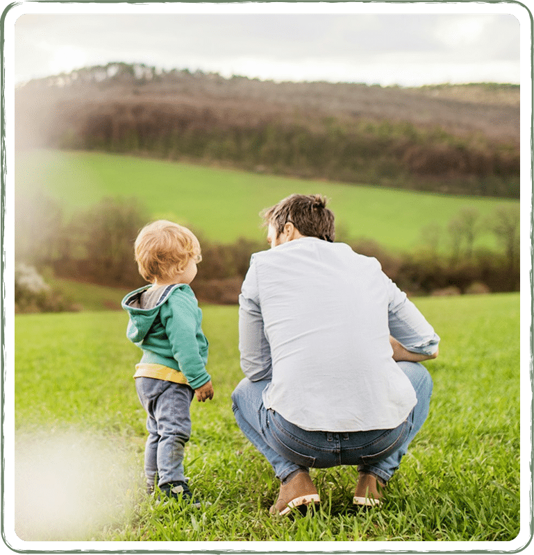 A father with his toddler son playing outdoor