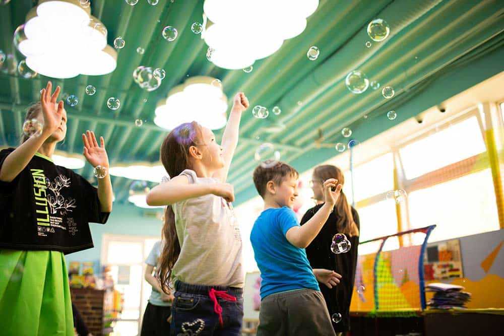 A group of young children standing next to each other.
