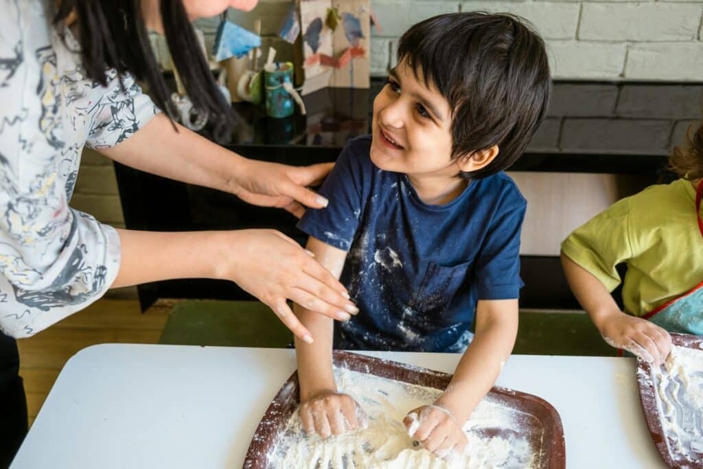 A woman and a boy making a dough