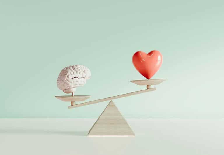 brain and heart on a balance scale