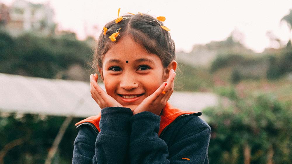 girl with her hands on her face