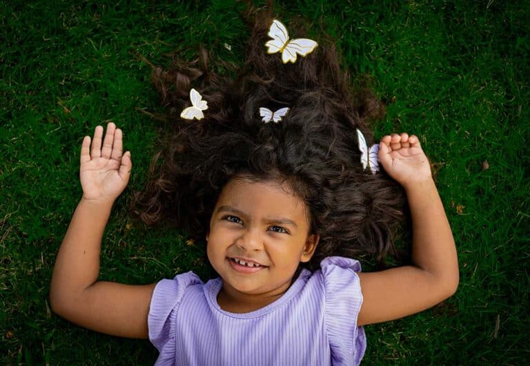 little girl lying on the grass