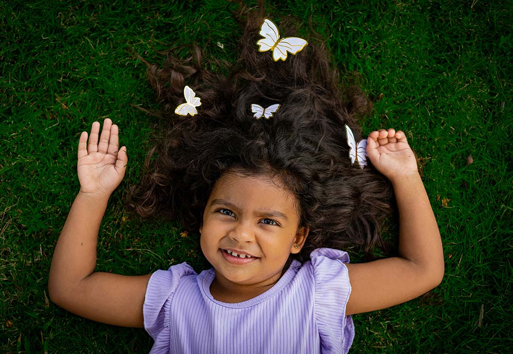 little girl lying on the grass