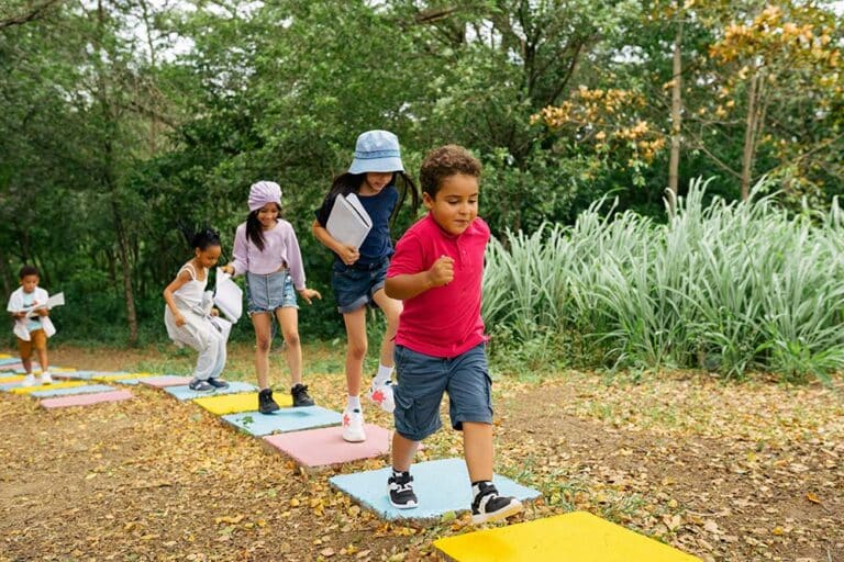 A group of children playing mini golf together.