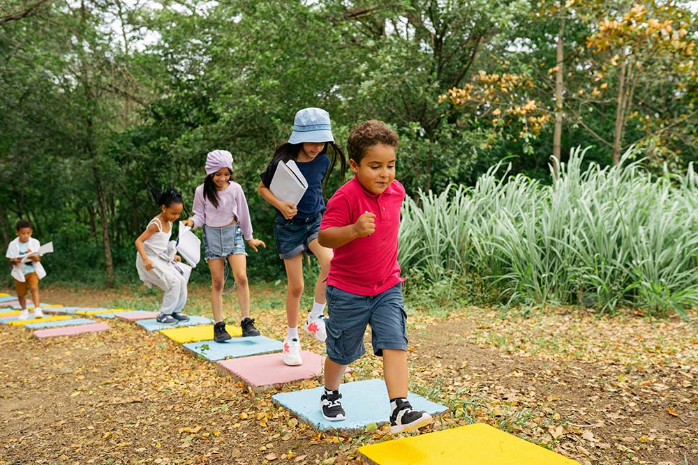 A group of children playing mini golf together.