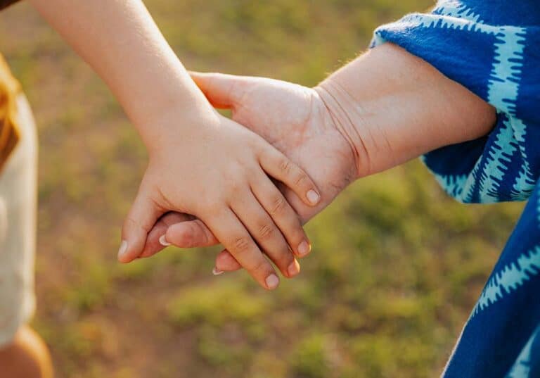 Two hands clasped together lovingly.